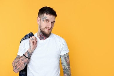 Photo of Portraithandsome hipster man on yellow background. Space for text
