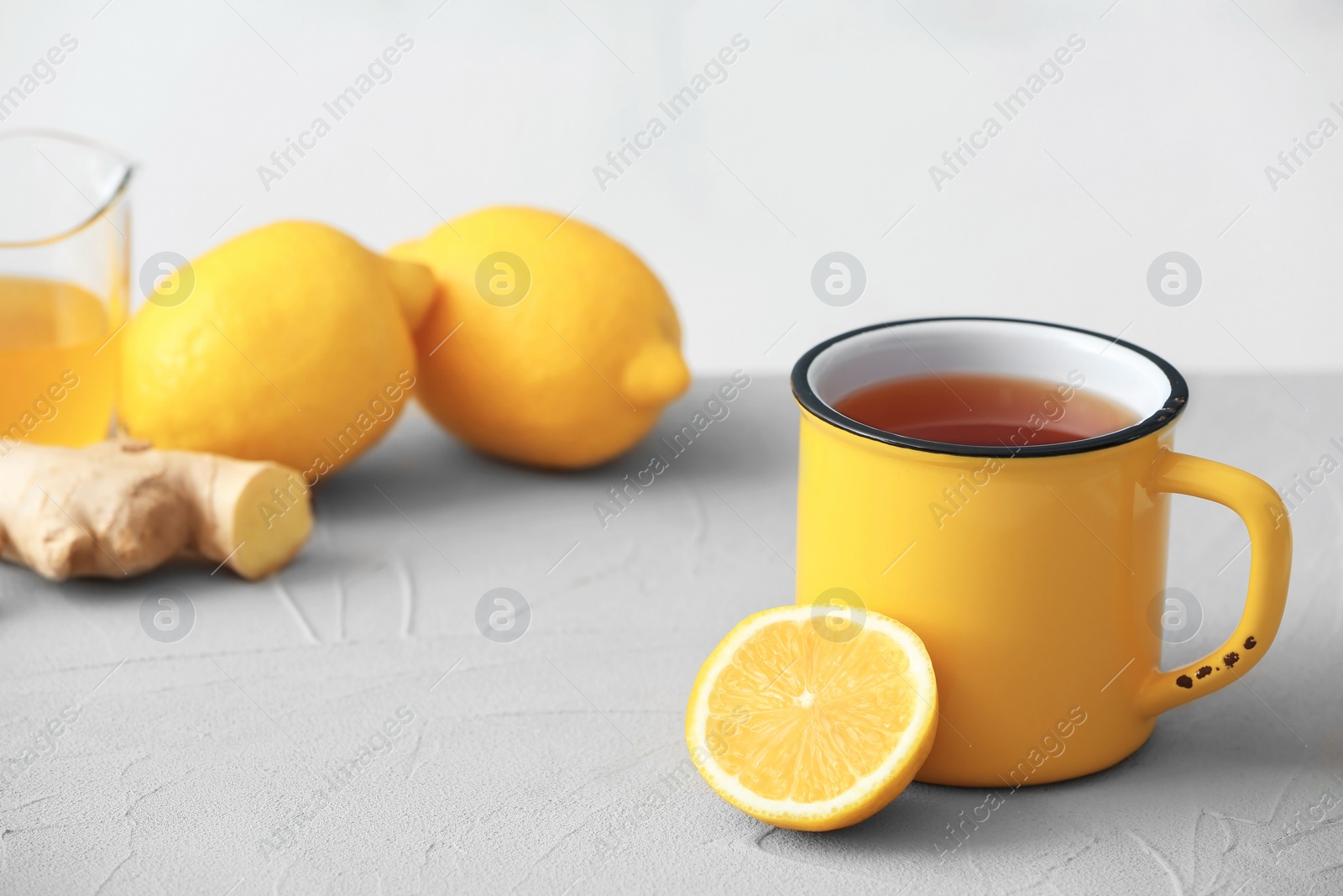 Photo of Cup of hot tea and lemon on table. Space for text