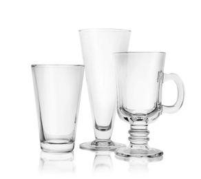 Photo of Set of empty glasses for different drinks on white background