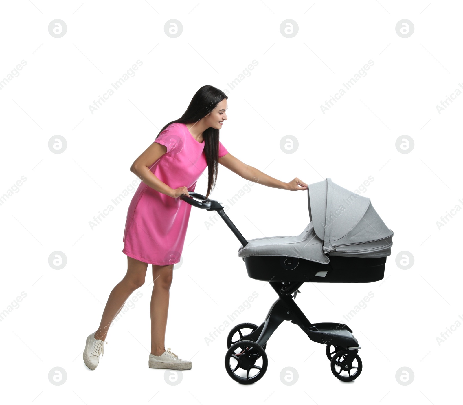 Photo of Happy young woman with baby stroller on white background