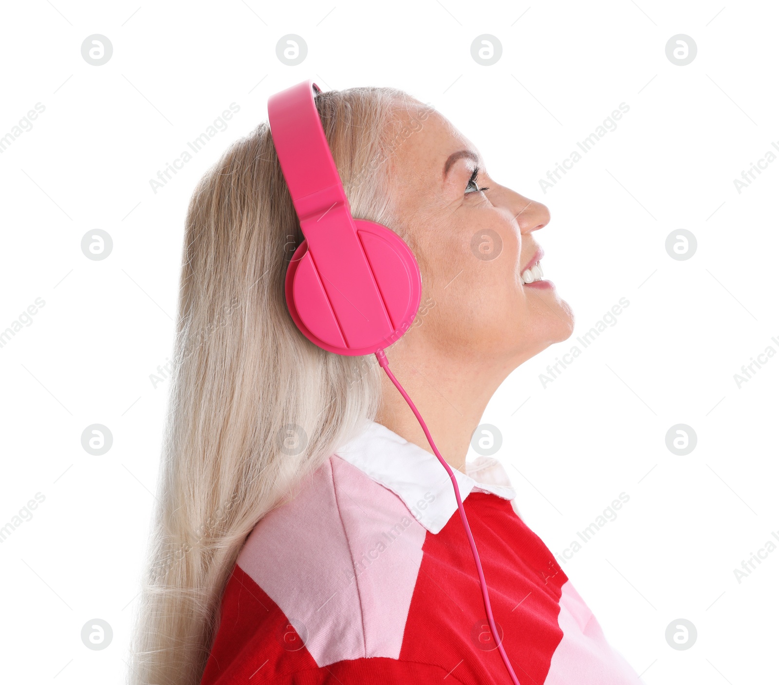 Photo of Mature woman enjoying music in headphones isolated on white