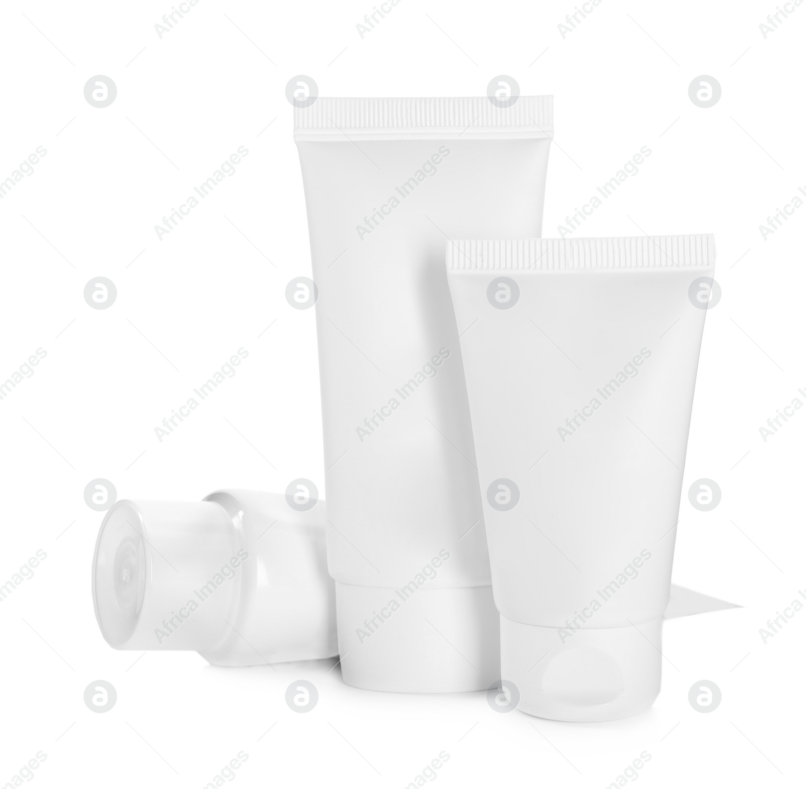 Photo of Blank tubes of cosmetic products on white background