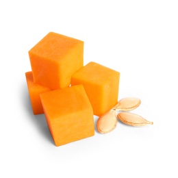 Pieces of ripe orange pumpkin and seeds on white background