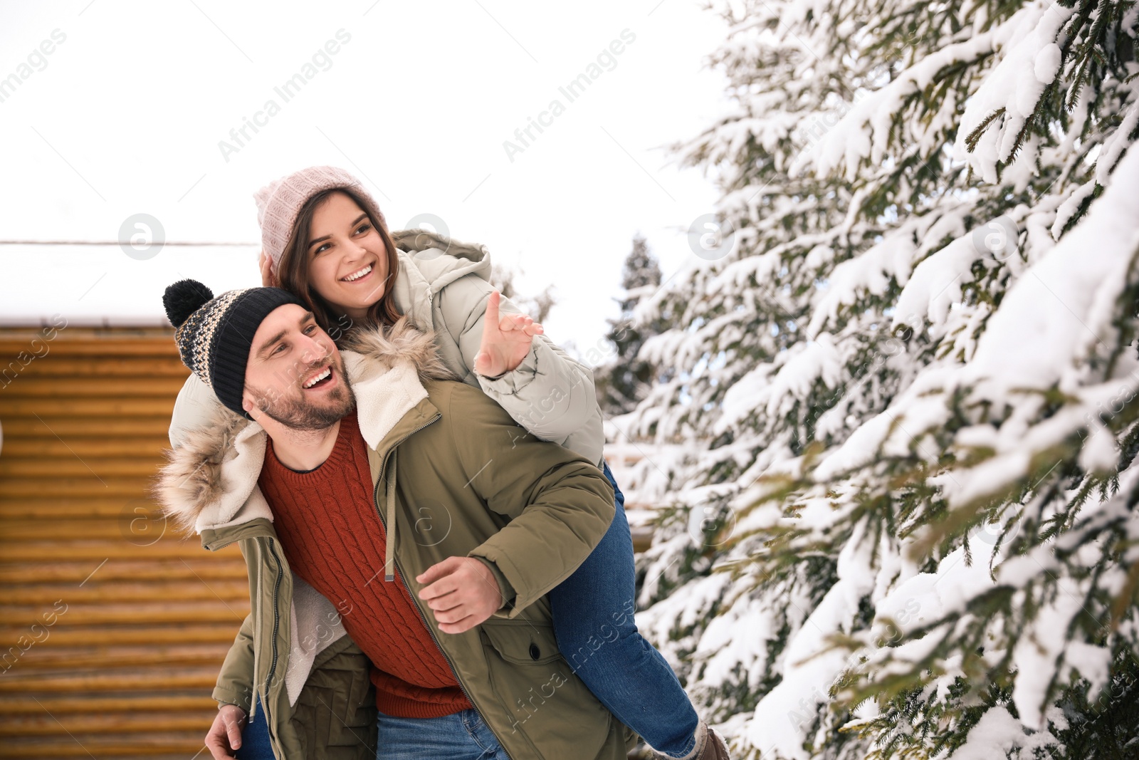 Photo of Happy couple spending time together on snowy day. Winter vacation