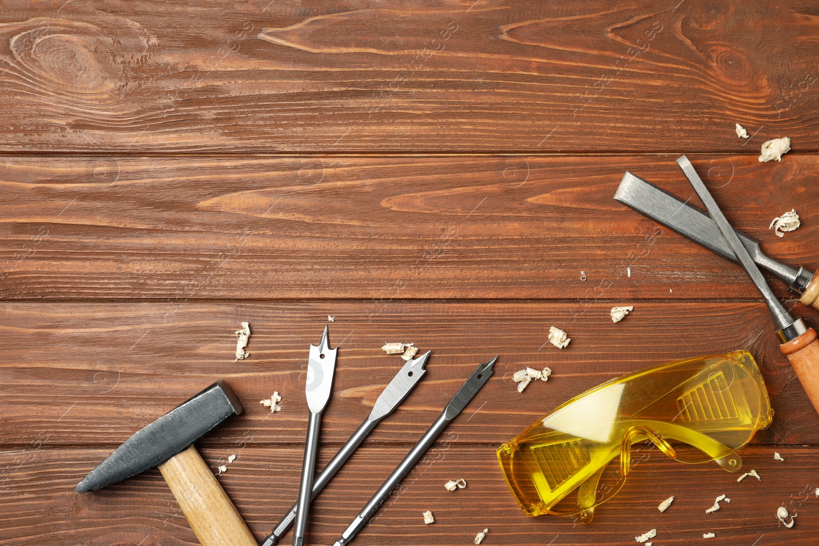 Photo of Flat lay composition with carpenter's tools on wooden background. Space for text