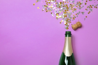 Photo of Creative flat lay composition with bottle of champagne and space for text on color background