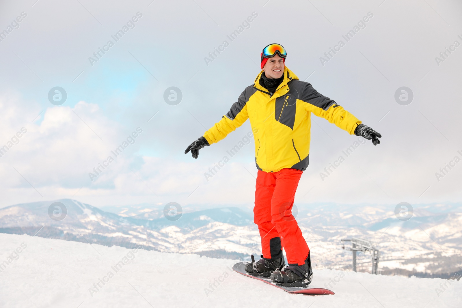 Photo of Male snowboarder on snowy hill. Winter vacation