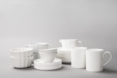 Set of clean tableware on grey background. Washing dishes