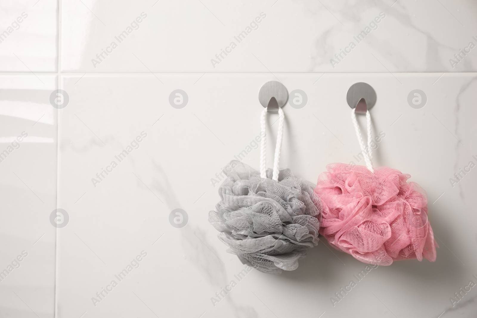 Photo of Shower puffs hanging in bathroom, space for text