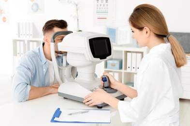 Photo of Ophthalmologist examining patient in clinic