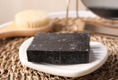 Natural tar soap on wicker mat, closeup