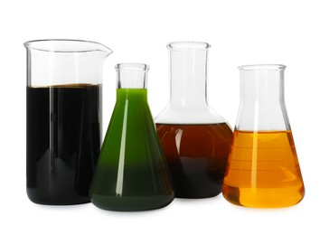 Photo of Beaker and flasks with different types of oil isolated on white