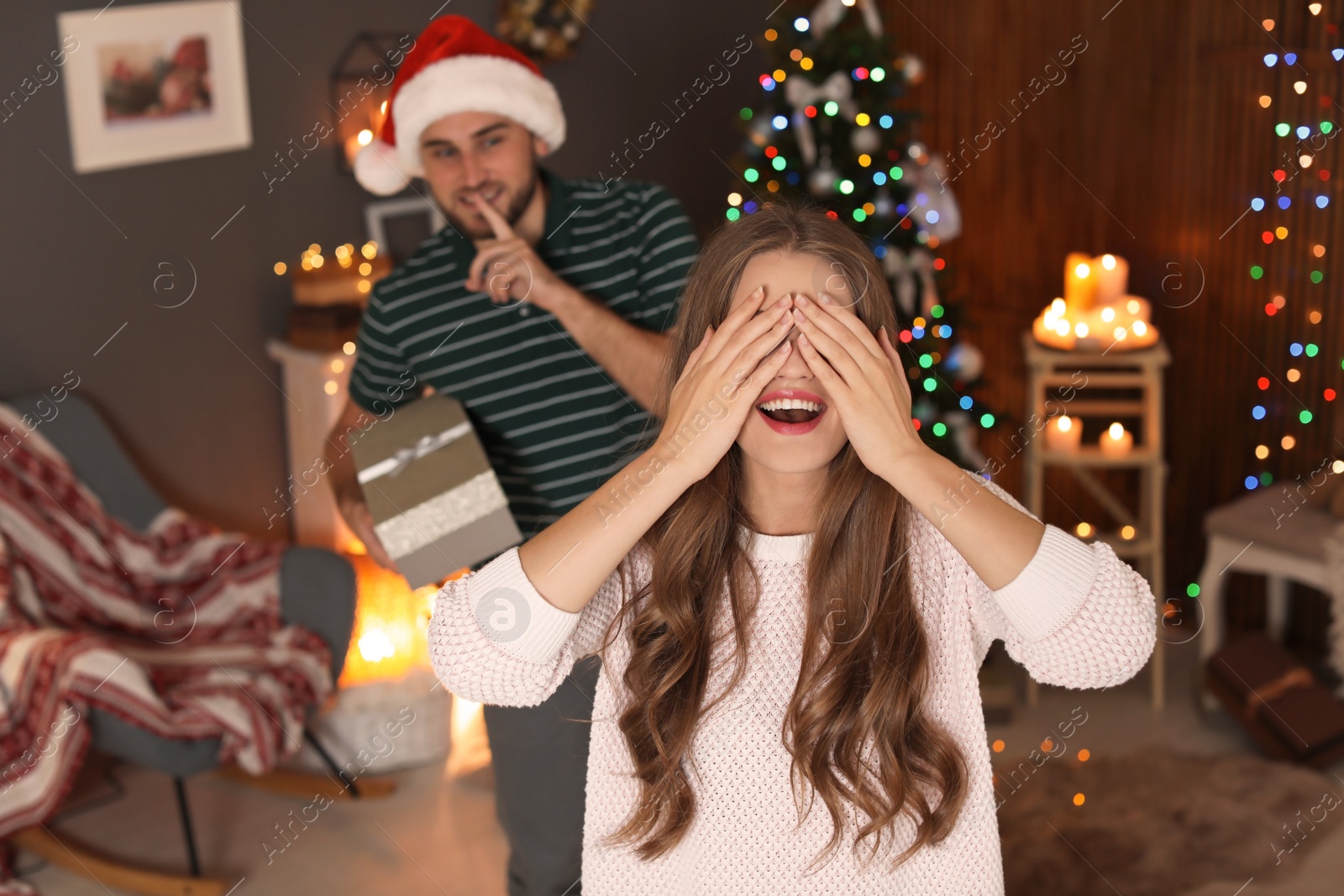 Photo of Happy young couple celebrating Christmas at home