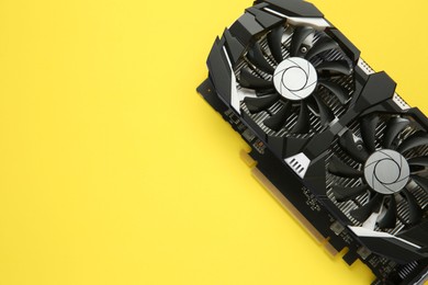 Photo of Computer graphics card on yellow background, top view. Space for text