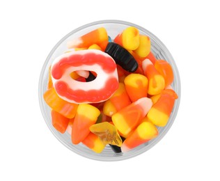 Photo of Bowl of delicious colorful candies isolated on white, top view. Halloween sweets