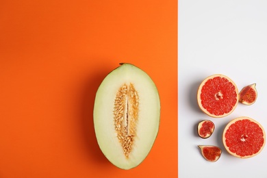 Photo of Flat lay composition with melon, other fruits and space for text on color background