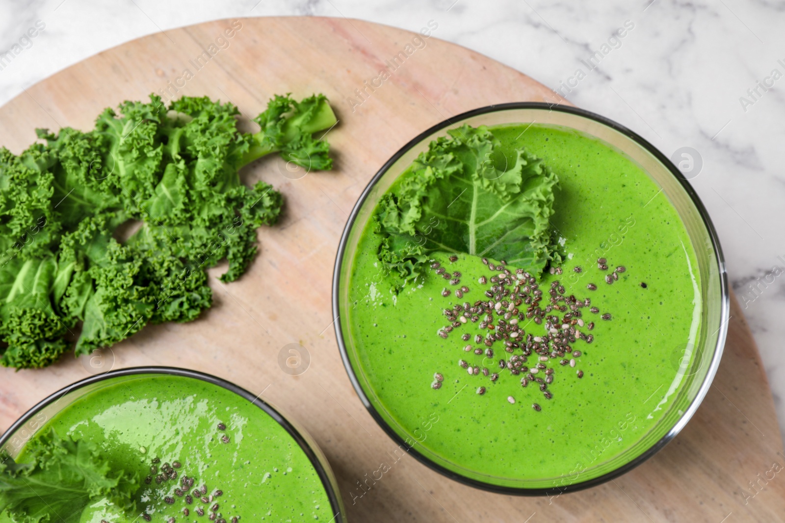 Photo of Tasty kale smoothie with chia seeds on table, flat lay