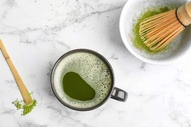 Flat lay composition with matcha tea on marble background