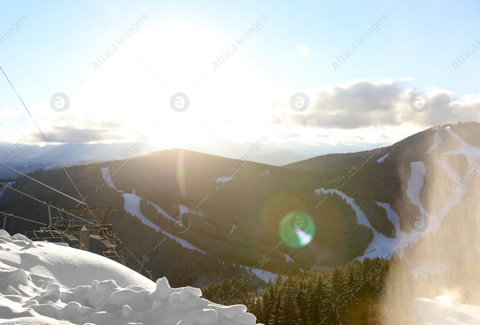 Photo of Beautiful mountain landscape with forest and ski lift on sunny day in winter