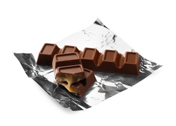 Photo of Delicious sweet chocolate bars with foil on white background