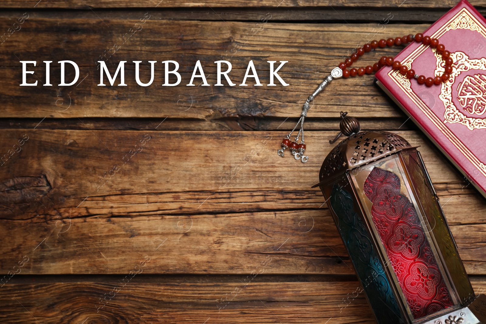 Image of Eid Mubarak greeting card. Arabic lantern, Quran and misbaha on wooden background, flat lay