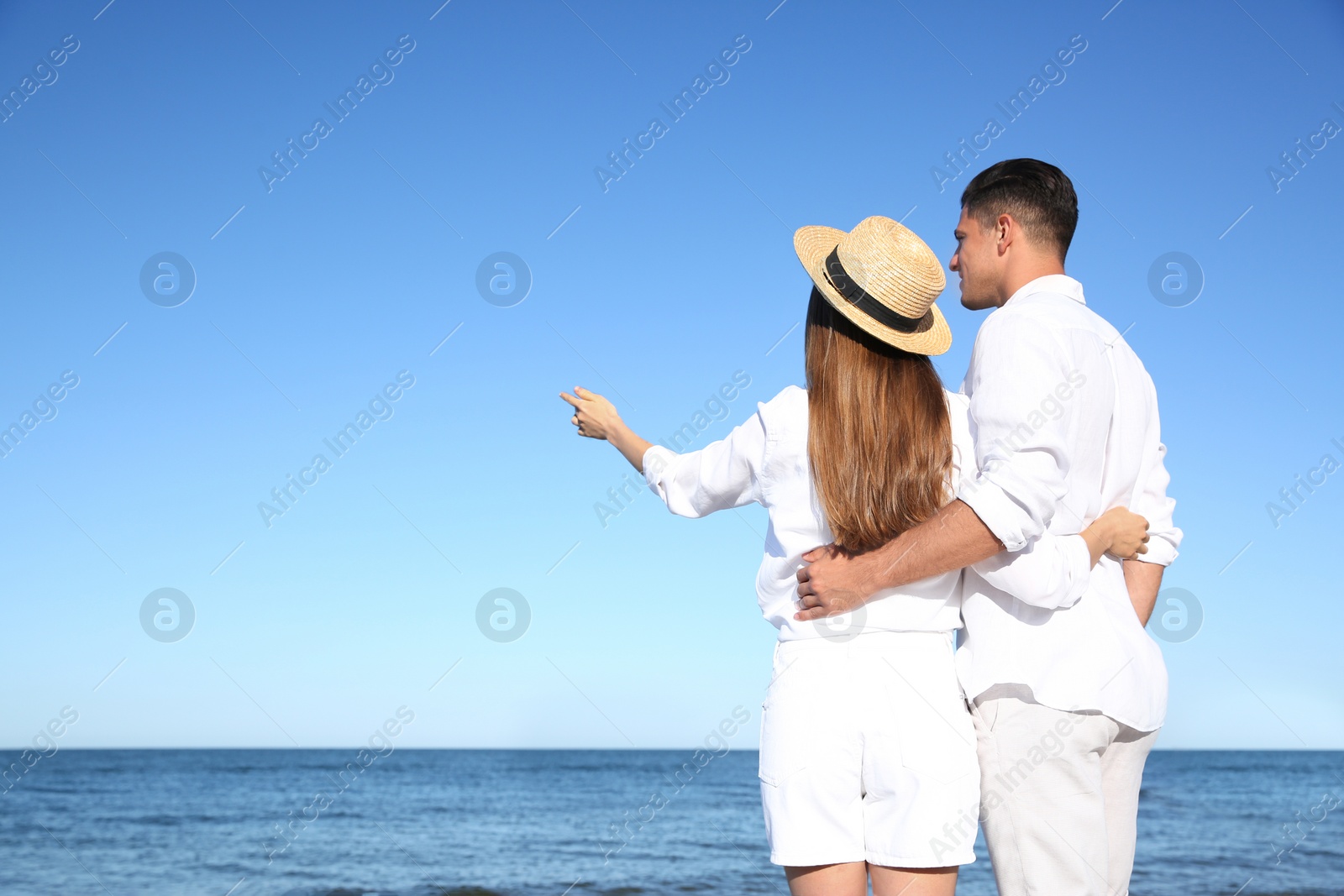 Photo of Lovely couple on beach. Space for text