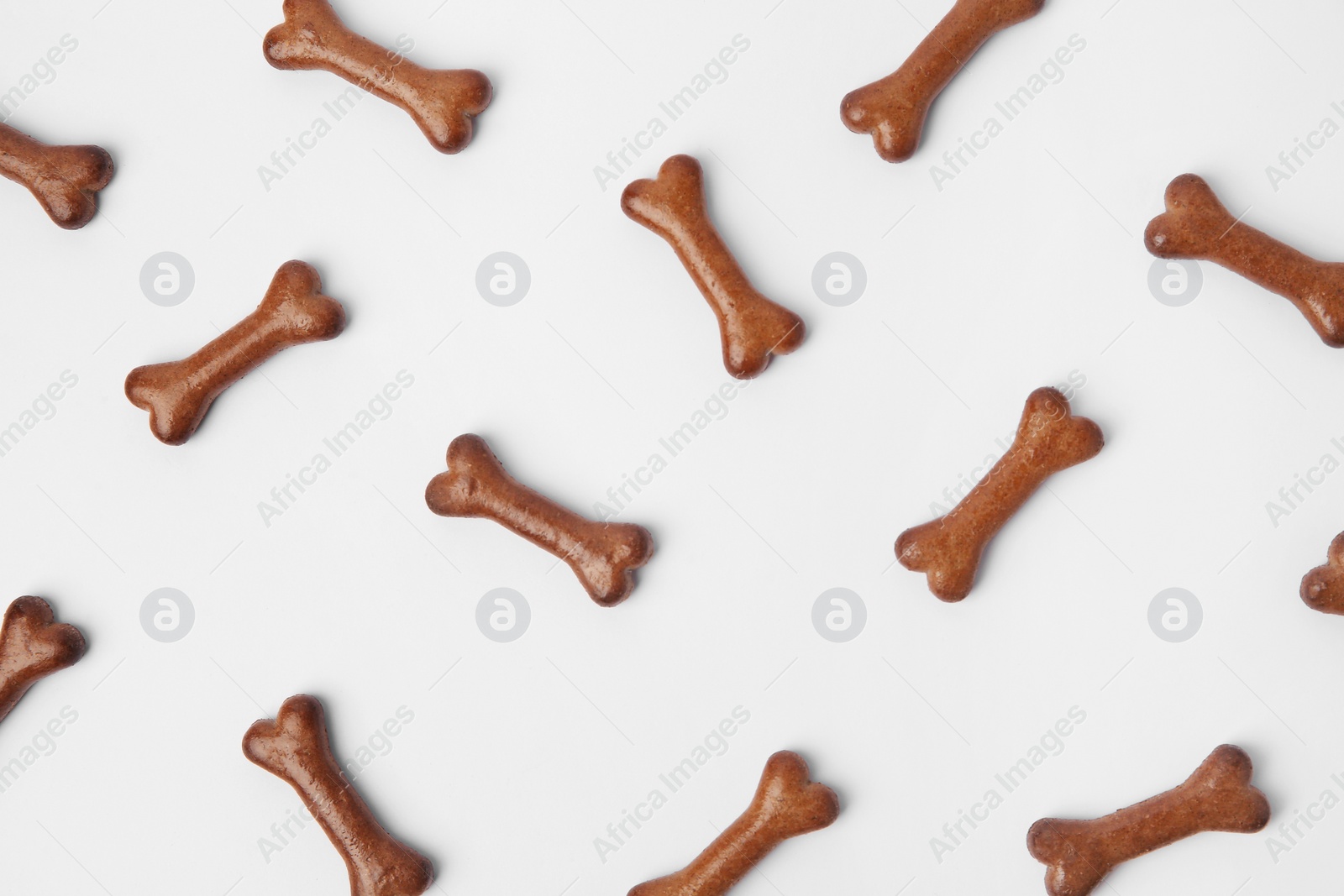 Photo of Flat lay composition with bone shaped dog cookies on white background