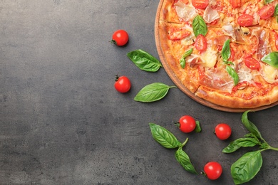 Delicious pizza with tomatoes and meat on table, top view