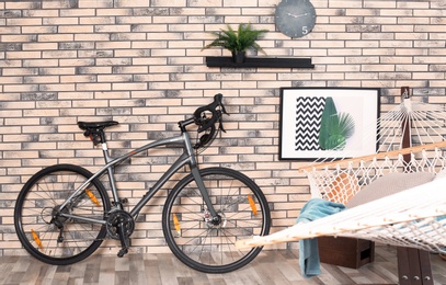 Photo of Modern bicycle and hammock in stylish room interior