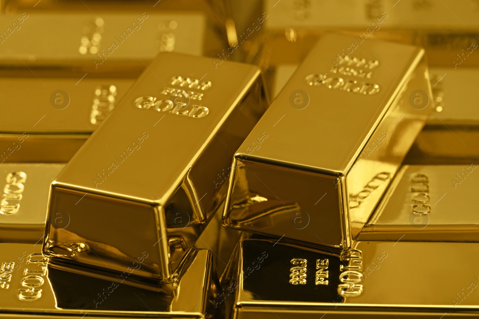 Photo of Many shiny gold bars as background, closeup