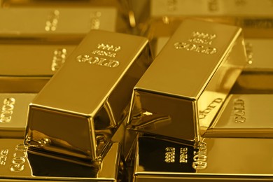 Many shiny gold bars as background, closeup