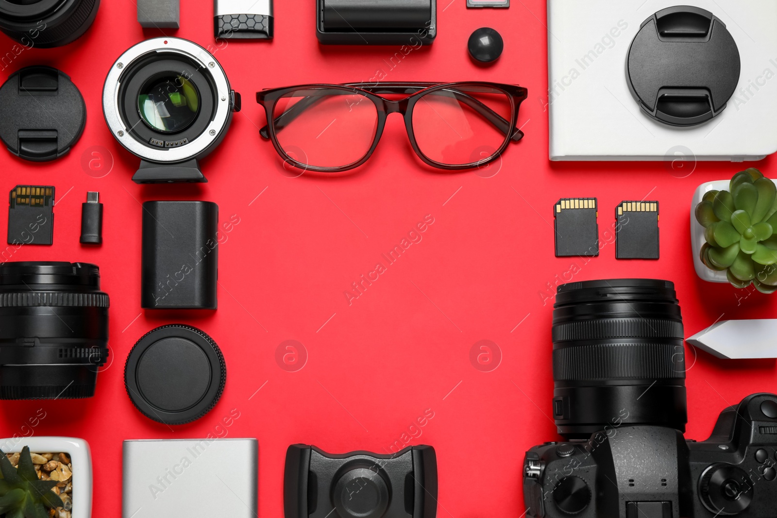 Photo of Flat lay composition with camera and video production equipment on red background. Space for text