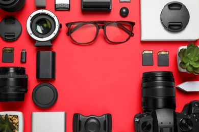 Photo of Flat lay composition with camera and video production equipment on red background. Space for text