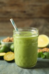 Fresh feijoa smoothie in glass on wooden table, closeup