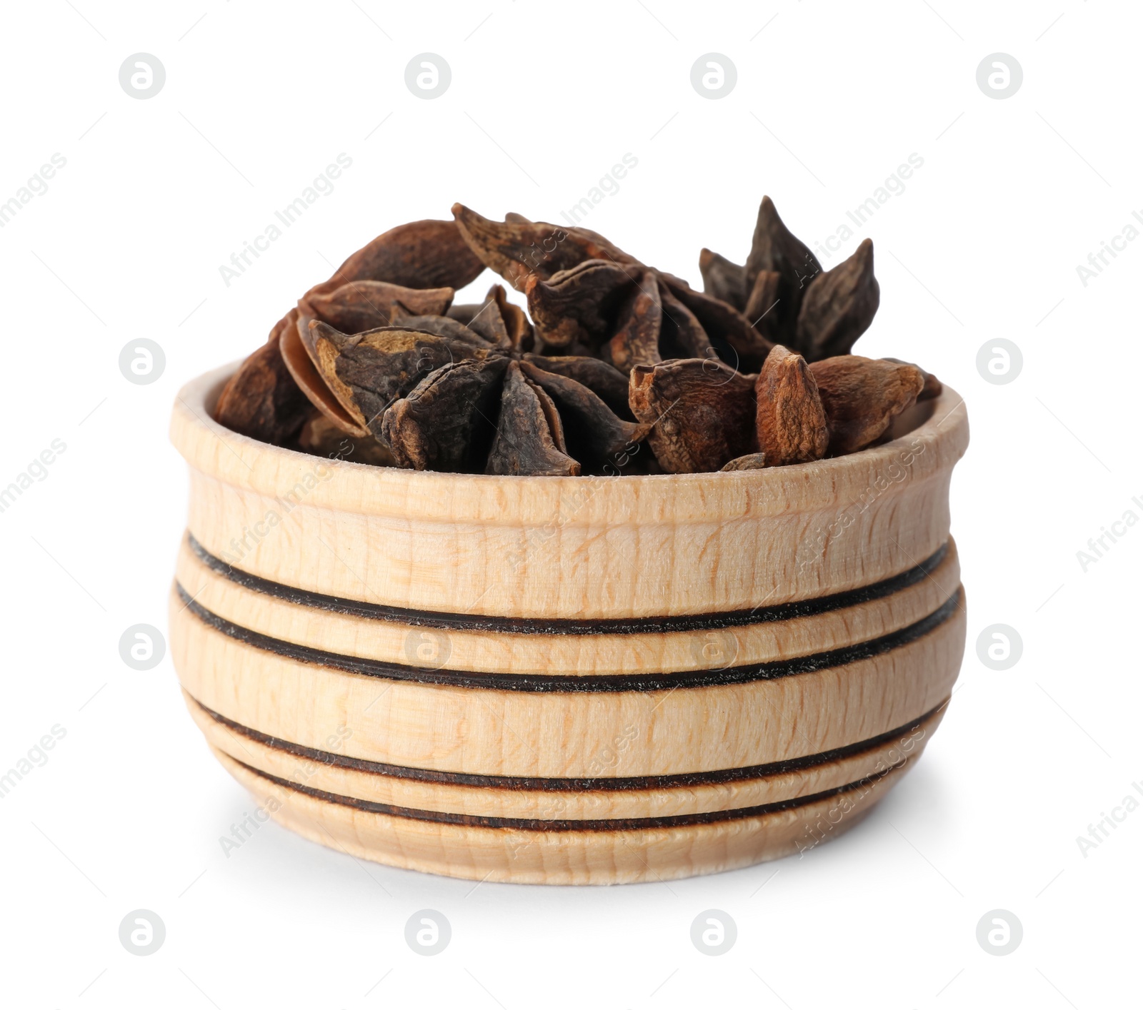 Photo of Wooden bowl with anise stars on white background. Different spices