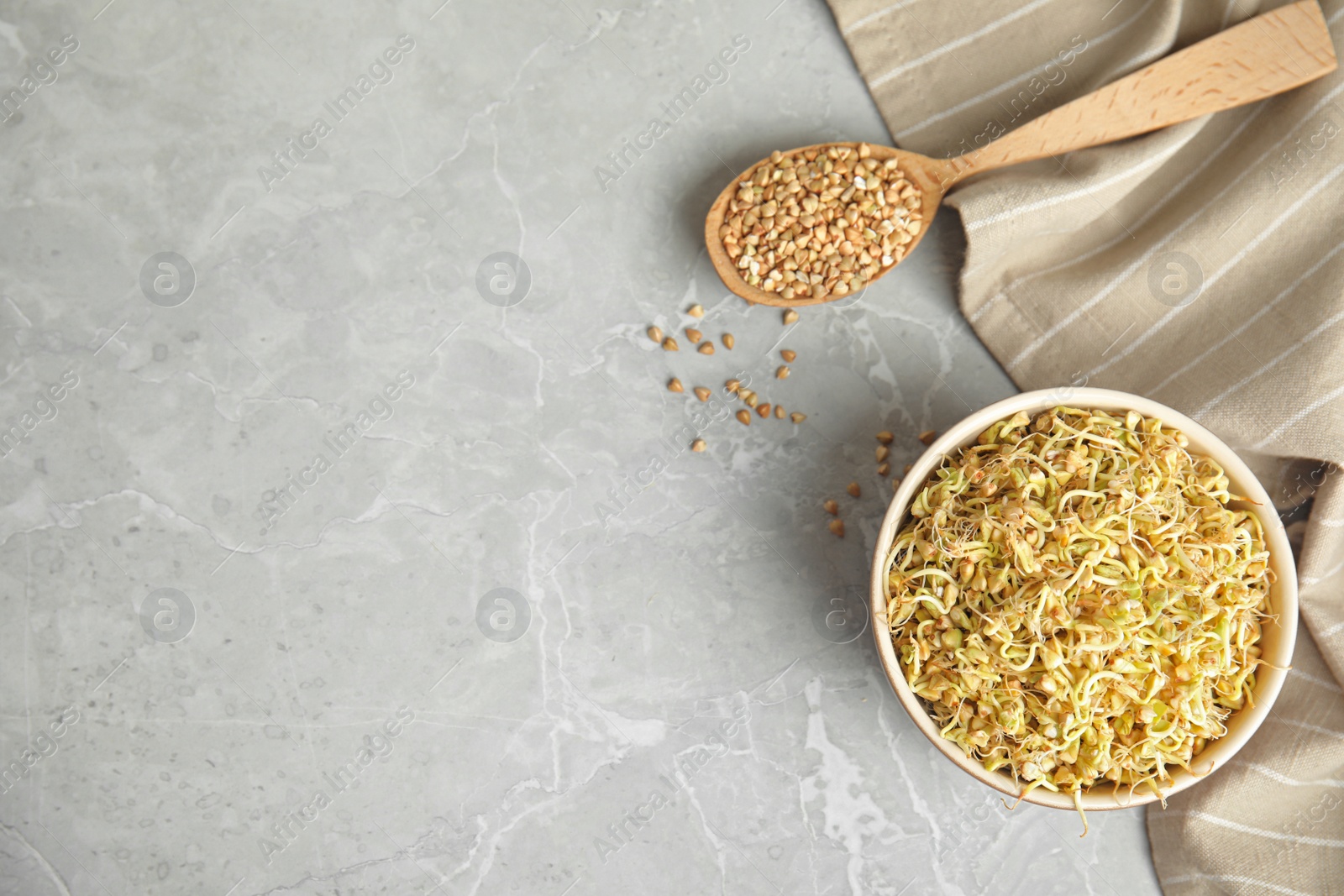 Photo of Flat lay composition with green buckwheat on light grey table, space for text