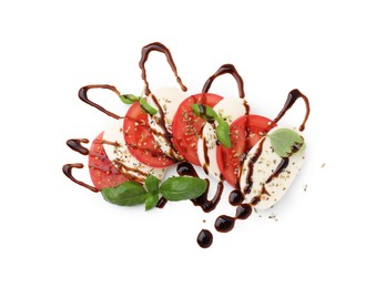 Photo of Tasty salad Caprese with mozzarella, tomatoes, basil and sauce on white background, top view