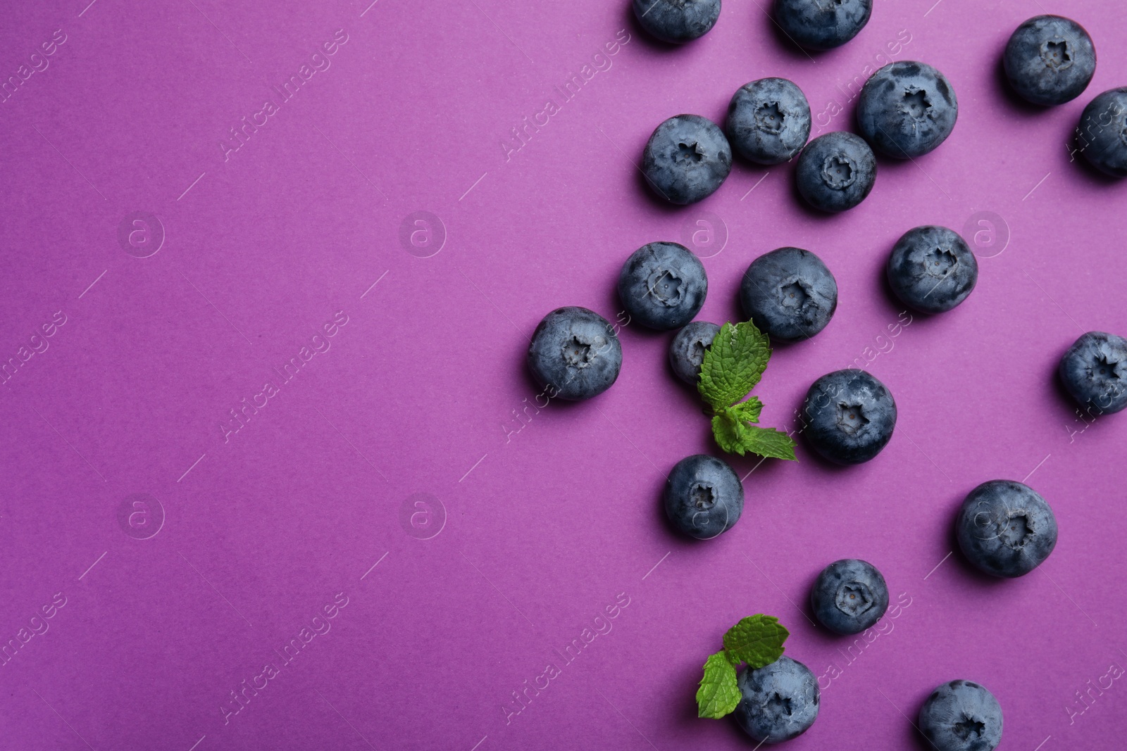 Photo of Flat lay composition with tasty blueberry and space for text on color background