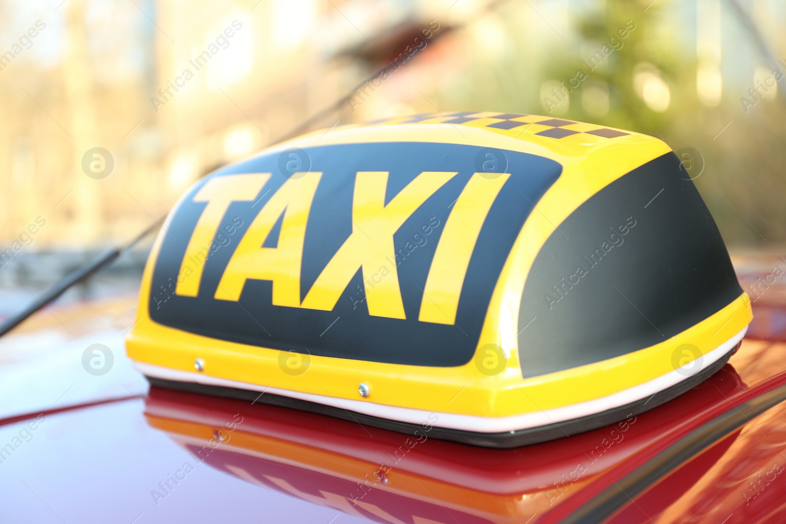 Photo of Roof light with word TAXI on car outdoors