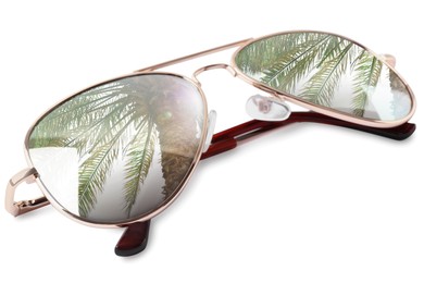 New stylish aviator sunglasses on white background. Sky and palm tree reflecting in lenses