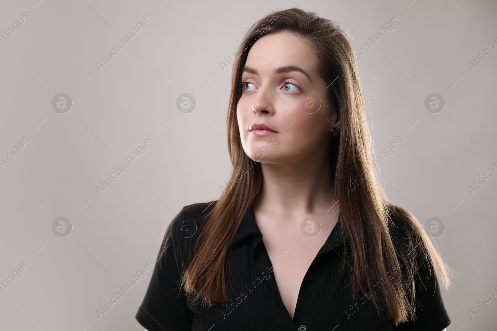 Photo of Portrait of beautiful woman on gray background, space for text