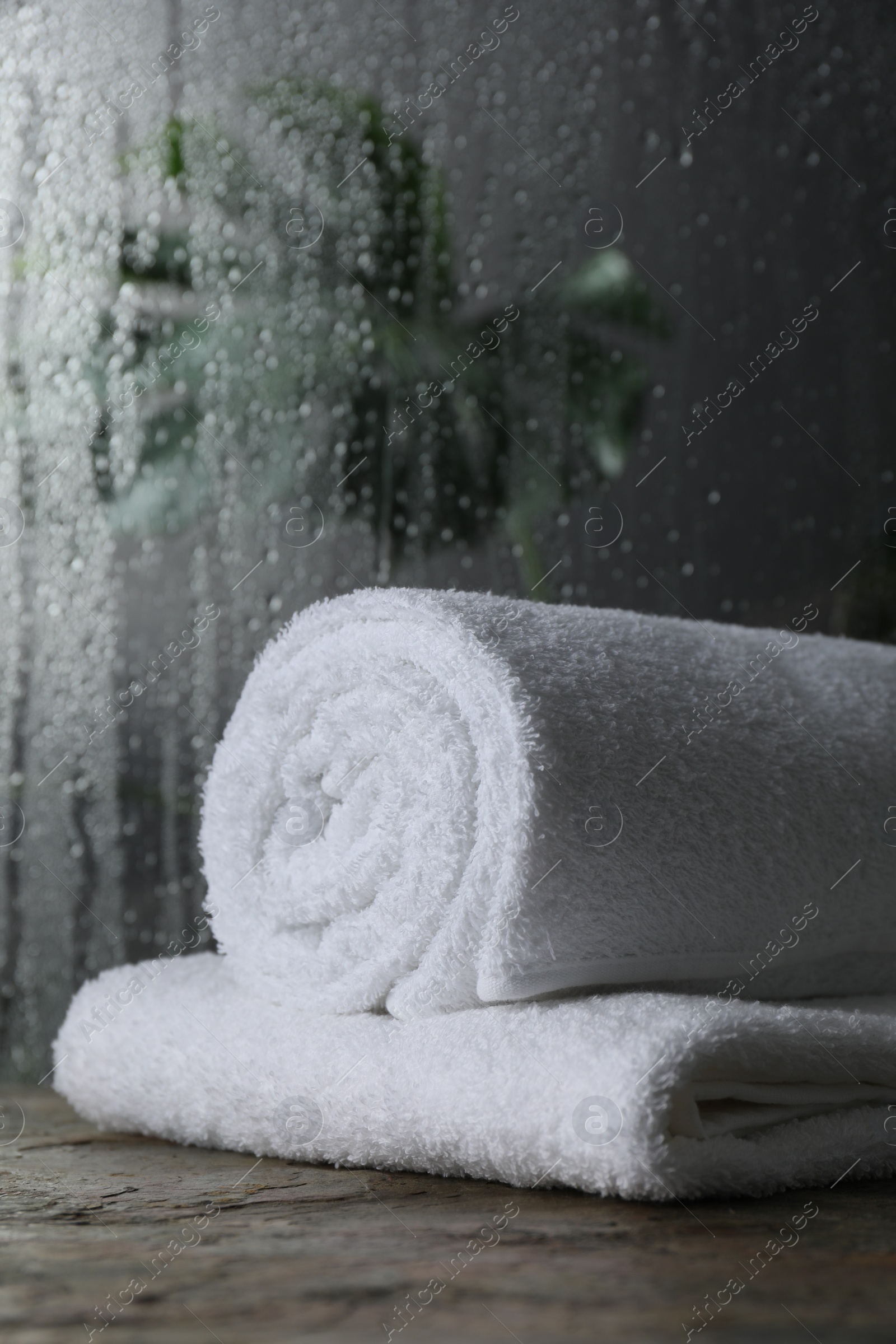 Photo of White terry towels on table in bathroom