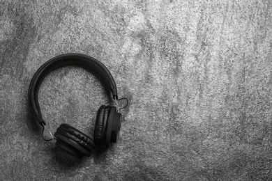 Photo of Stylish headphones on grey background, top view. Space for text