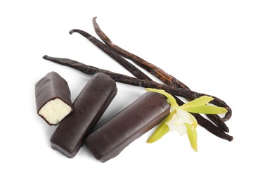 Photo of Glazed curd cheese bars, vanilla pods and flower isolated on white