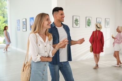 Photo of Happy couple at exhibition in art gallery