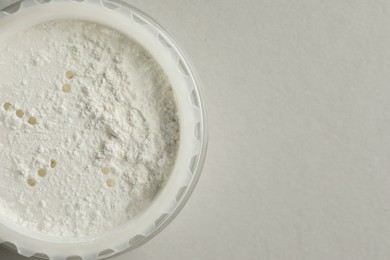 Rice loose face powder on light grey background, top view. Space for text