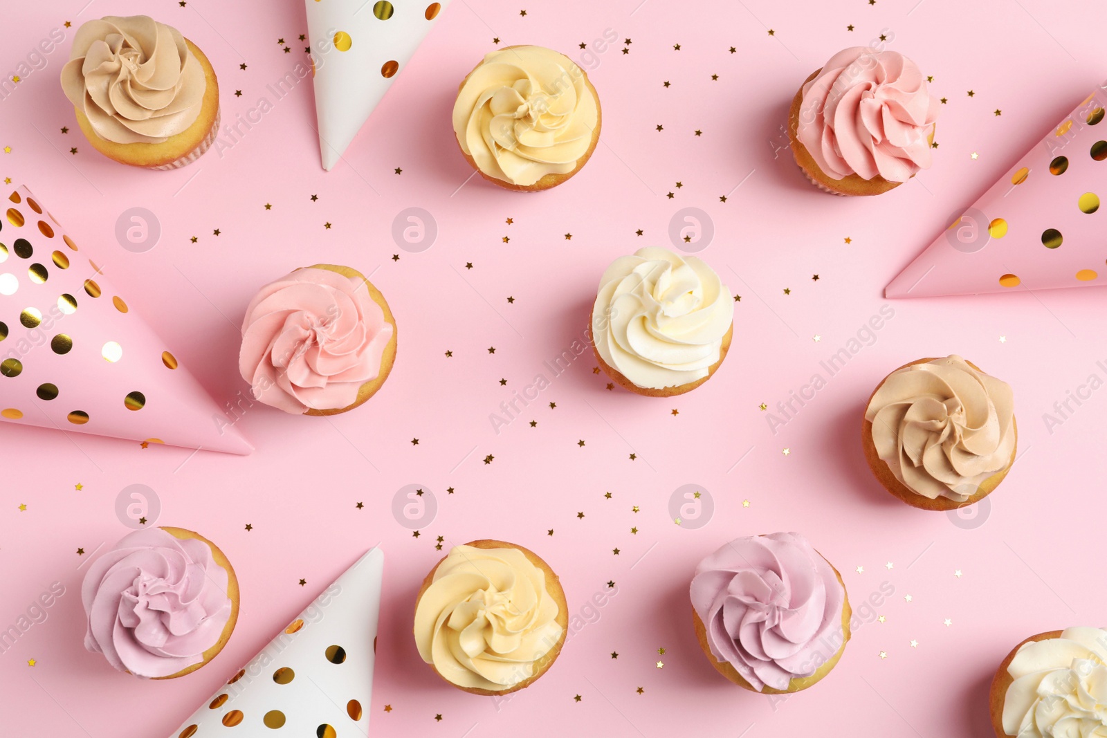 Photo of Flat lay composition with delicious birthday cupcakes on color background