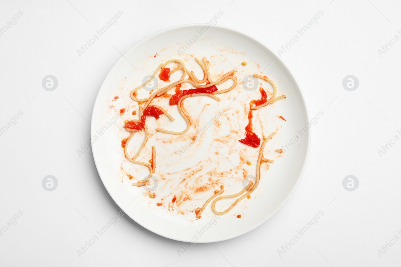 Photo of Dirty plate with food leftovers on white background, top view