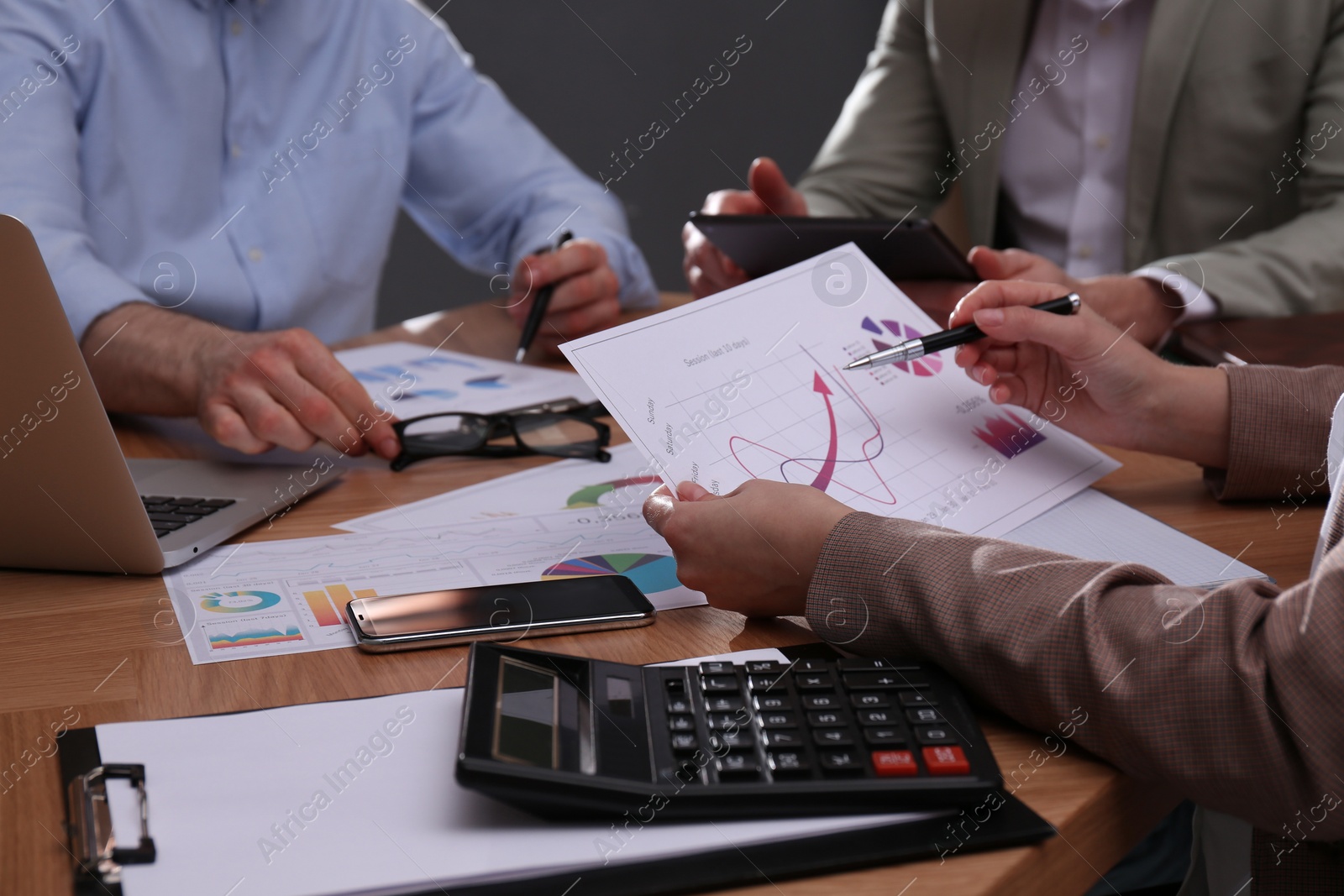 Photo of Business people working with documents at table in office, closeup. Investment analysis