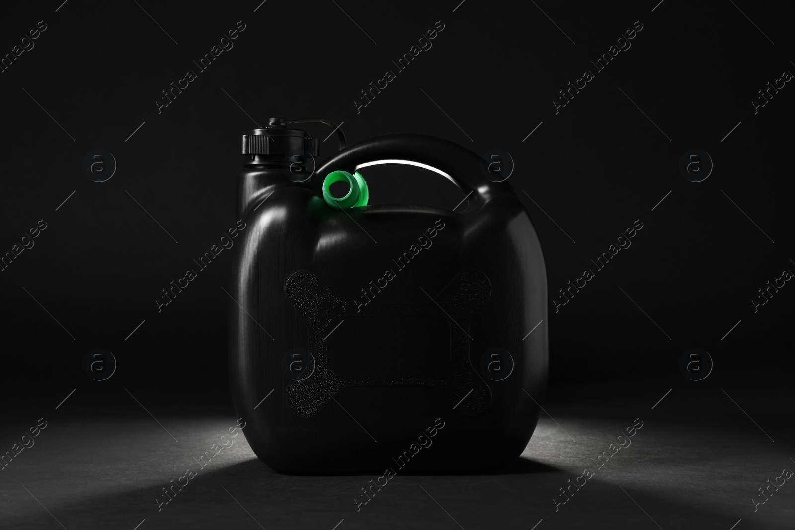 Photo of One new plastic canister on black background